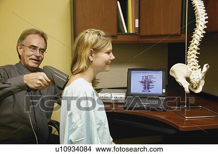 Doctor examining patient's back View Large Photo Image Picture - Doctor examining patient's back. Fotosearch