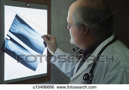 Stock Photograph - Doctor examining x-ray. Fotosearch