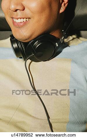 Stock Image - Enjoying loud music on headphones. Fotosearch