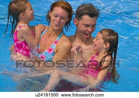 Stock Image - Family having fun in swimming pool. Fotosearch