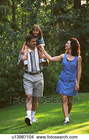 Family walking in park View Large Photo Image Picture - Family walking in park. Fotosearch