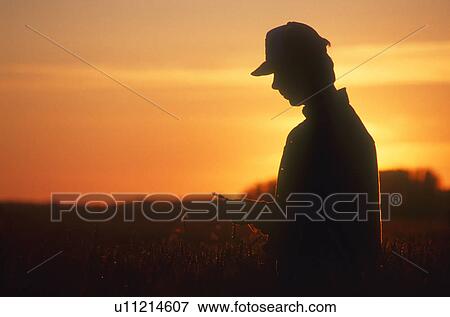Farmer looking at crop View Large Photo Image Stock Photo - Farmer looking at crop. Fotosearch