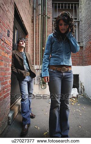 Stock Photo - Fashionable couple in an alley. Fotosearch