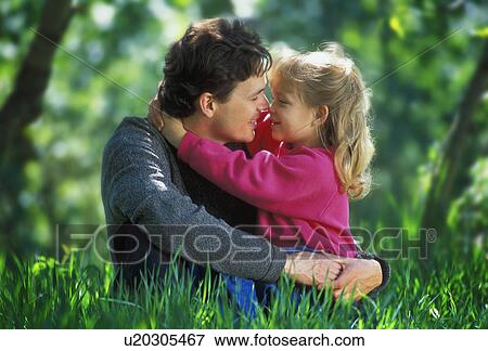 Father and daughter hugging in the park View Large Photo Image Stock Photo - Father and daughter hugging in the park. Fotosearch