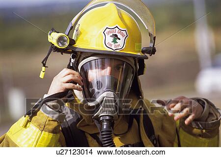 Fireman adjusting mask View Large Photo Image Picture - Fireman adjusting mask. Fotosearch