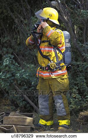 Stock Photo - Fireman putting on equipment. Fotosearch