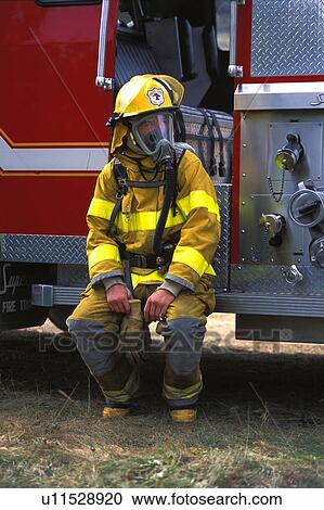 Fireman sitting on fire truck View Large Photo Image Stock Image - Fireman sitting on fire truck. Fotosearch