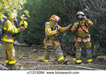 Picture - Firemen putting on equipment. Fotosearch