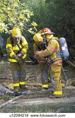 Stock Photo - Firemen putting on equipment. Fotosearch