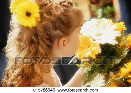 Flower girl smells bouquet View Large Photo Image Stock Photograph - Flower girl smells bouquet. Fotosearch