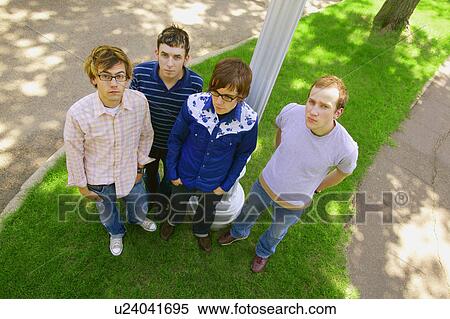 Four young men hanging out View Large Photo Image Stock Photography - Four young men hanging out. Fotosearch