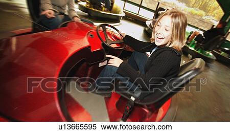 Stock Photography - Girl at an amusement park. Fotosearch