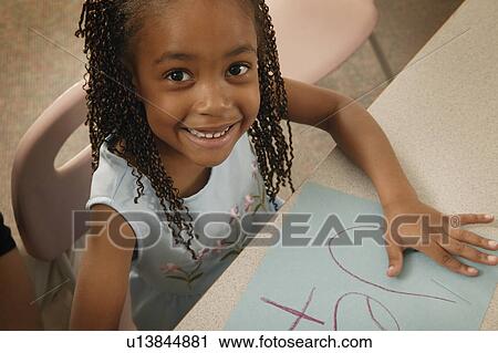 Girl colors a picture View Large Photo Image Stock Image - Girl colors a picture. Fotosearch
