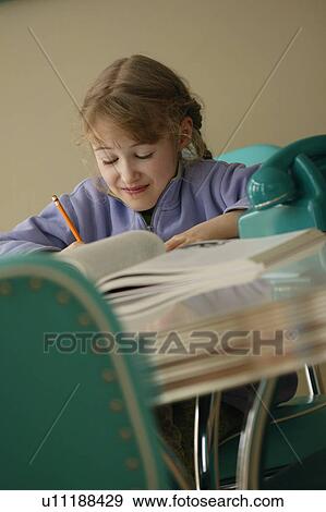 Girl doing homework View Large Photo Image Stock Photo - Girl doing homework. Fotosearch