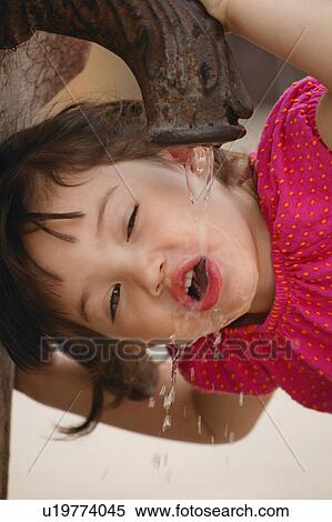Girl drinking from water fountain View Large Photo Image Stock Photography - Girl drinking from water fountain. Fotosearch
