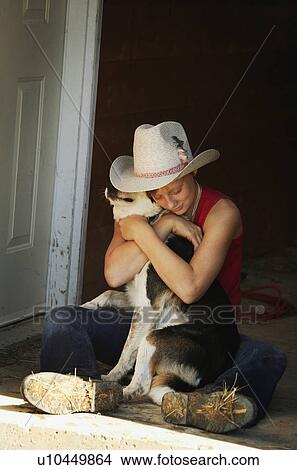 Picture - Girl hugging her dog. Fotosearch