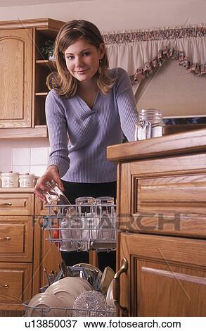 Girl loading dishwasher View Large Photo Image Stock Photo - Girl loading dishwasher. Fotosearch