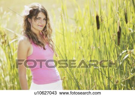 Girl posing in reeds View Large Photo Image Stock Image - Girl posing in reeds. Fotosearch