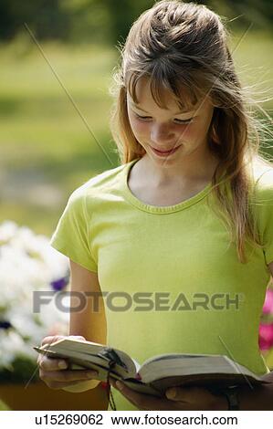Girl reads a book View Large Photo Image Stock Image - Girl reads a book. Fotosearch