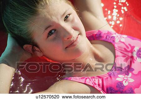 Girl relaxes in bathing suit View Large Photo Image Stock Image - Girl relaxes in bathing suit. Fotosearch