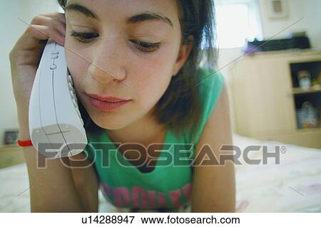 Girl talks on the phone View Large Photo Image Stock Photo - Girl talks on the phone. Fotosearch