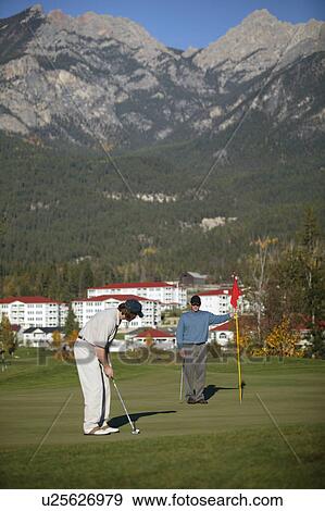 Golfers on a beautiful course View Large Photo Image Stock Photo - Golfers on a beautiful course. Fotosearch