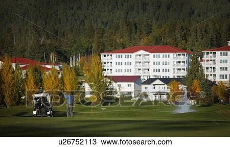 Stock Image - Golfing at a resort. Fotosearch