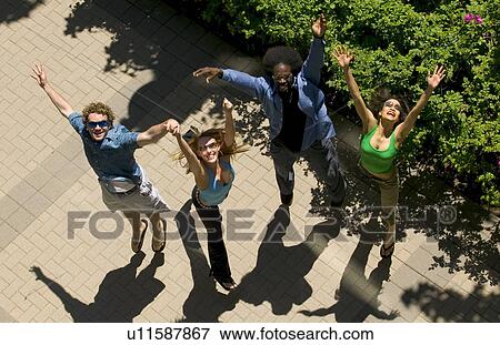 Stock Photo - Group of friends jumping for joy. Fotosearch