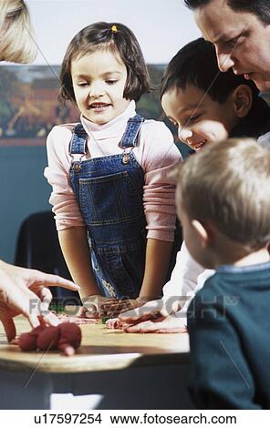 Group of people playing with playdoh View Large Photo Image Picture - Group of people playing with playdoh. Fotosearch