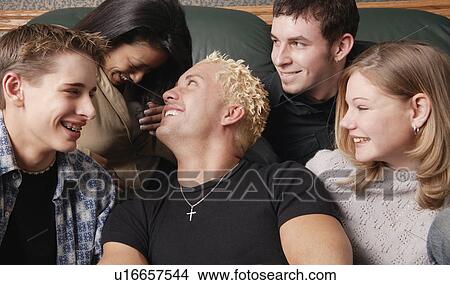 Group of young people laughing together View Large Photo Image Picture - Group of young people laughing together. Fotosearch