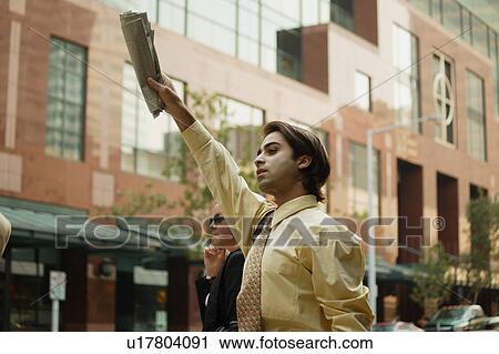 Stock Image - Hailing a cab. Fotosearch