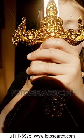 Hands clasping ornamental sword View Large Photo Image Stock Photography - Hands clasping ornamental sword. Fotosearch