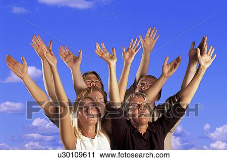 Stock Image - Hands raised in worship. Fotosearch