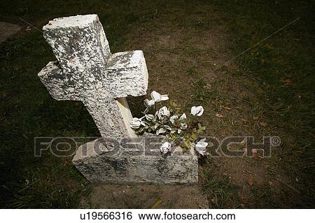 Stock Photograph - Headstone with flowers. Fotosearch