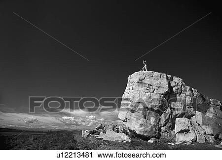 Hiker on top of large boulder in black and white View Large Photo Image Stock Image - Hiker on top of large boulder in black and white. Fotosearch