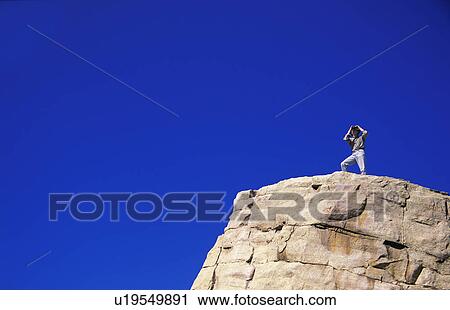 Hiker with binoculars on cliff edge View Large Photo Image Stock Image - Hiker with binoculars on cliff edge. Fotosearch