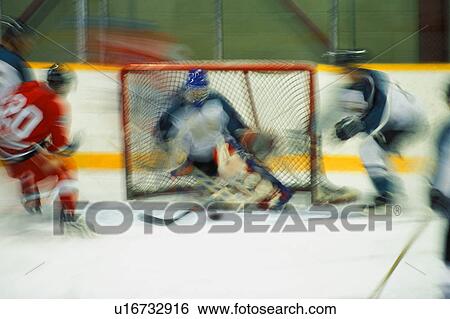 Hockey player shooting on goal View Large Photo Image Stock Photograph - Hockey player shooting on goal. Fotosearch