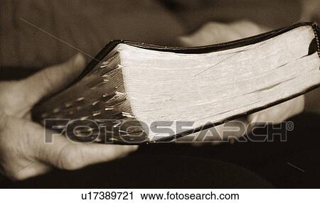 Stock Image - Holding a Bible. Fotosearch