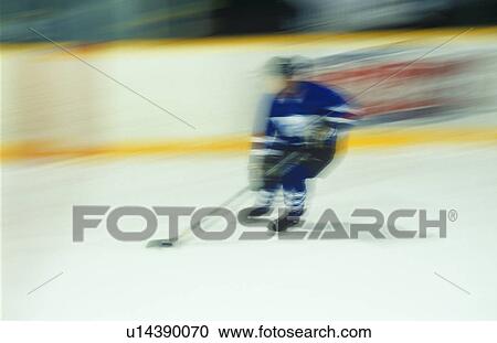 Stock Image - Ice hockey player at speed. Fotosearch