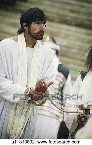 Stock Image - Jesus tied with ropes and arrested. Fotosearch