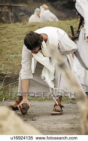 Stock Photography - Jesus writes in the sand. Fotosearch