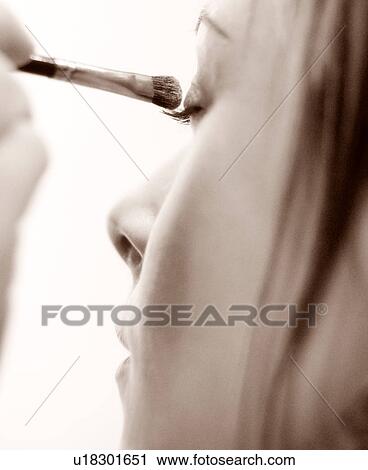 Lady applying eye shadow View Large Photo Image Stock Image - Lady applying eye shadow. Fotosearch