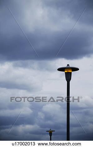 Lamp posts and cloudy sky View Large Photo Image Stock Image - Lamp posts and cloudy sky. Fotosearch