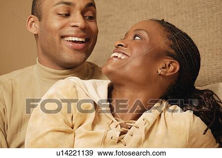 Stock Photo - Laughing at each other. Fotosearch
