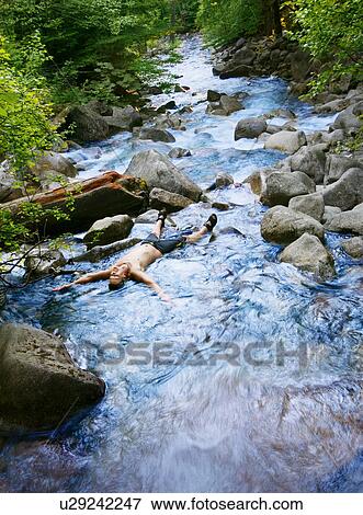 Stock Photo - Laying in a stream. Fotosearch