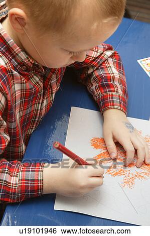 Little boy in kindergarten drawing a Halloween picture in his class View Large Photo Image Stock Photograph - Little boy in kindergarten drawing a Halloween picture in his class. Fotosearch