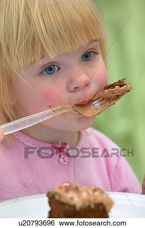 Little girl eating Birthday cake View Large Photo Image Stock Photograph - Little girl eating Birthday cake. Fotosearch