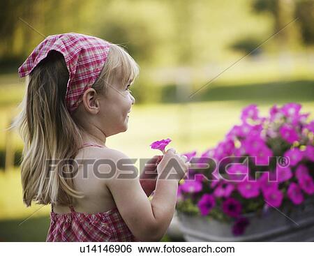 Stock Photograph - Little girl with pink flower. Fotosearch