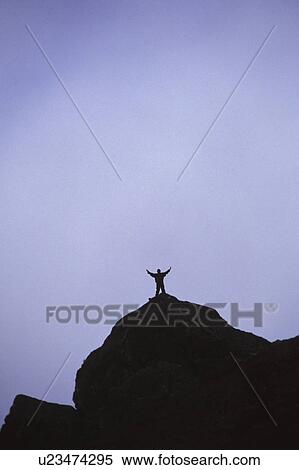 Lone hiker on top of mountain peak View Large Photo Image Stock Photography - Lone hiker on top of mountain peak. Fotosearch