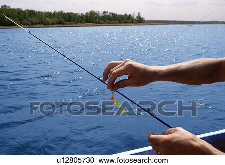 Lure being put on fishing line View Large Photo Image Stock Image - Lure being put on fishing line. Fotosearch